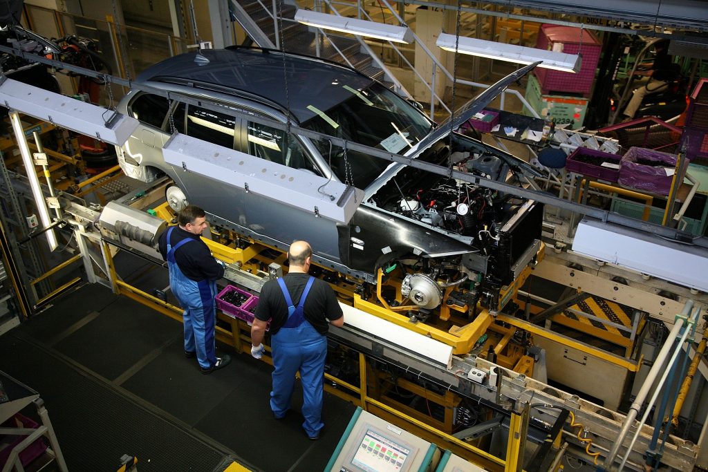 MUNICH, GERMANY - OCTOBER 17: Workers construct BMW 3 series cars in the Munich BMW plant during a guided tour after the opening ceremony of BMW World on October 17, 2007 in Munich, Germany. BMW World is a representative, architecturally spectacular company building next to the BMW headquarter. It is multifunctional, combining car delivery and museum. (Photo by Johannes Simon/Getty Images)