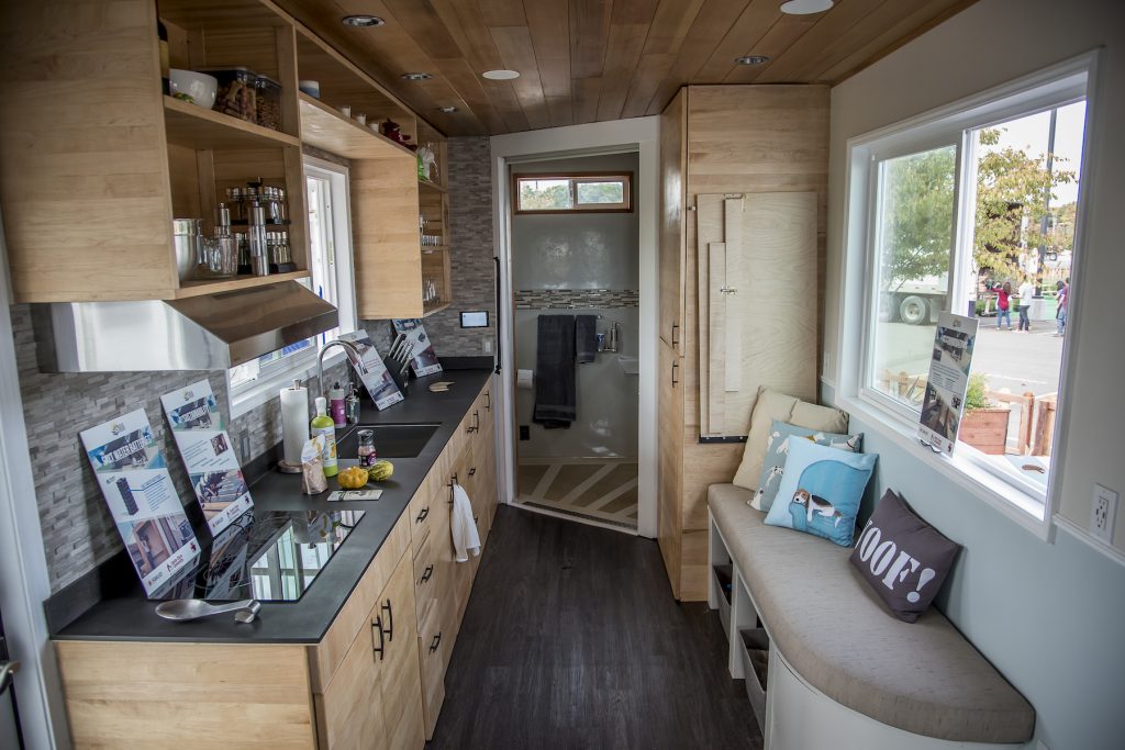 Images of the interior of Santa Clara University's rEvolve House during the 2016 Tiny House Competition in Sacramento on October 13, 2016. When the contest is over, the 238-square-foot solar-powered home will go to Operation Freedom Paws (OFP), a 501(c)3 nonprofit organization empowering military veterans and others with disabilities to restore their independence by teaming them up with a service dog. Sacramento Municipal Utility District (SMUD) is hosting a Tiny House Competition modeled after the Solar Decathlon created by the U.S. Department of Energy. The purpose of the competition is to explore renewable energy, green building techniques and sustainable living while constructing net-zero energy houses. (Photo credit: Joanne H. Lee/Santa Clara University)