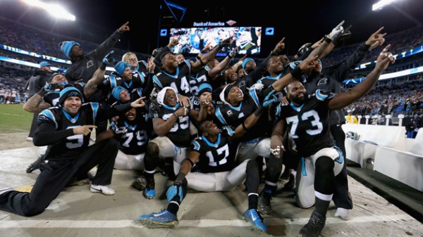 CHARLOTTE, NC - JANUARY 03:  Cam Newton #1 of the Carolina Panthers organizes a team photo in the bench area during their game against the Tampa Bay Buccaneers at Bank of America Stadium on January 3, 2016 in Charlotte, North Carolina.  The Panthers won 38-10 to clinch home field advantage for the playoffs  (Photo by Streeter Lecka/Getty Images)